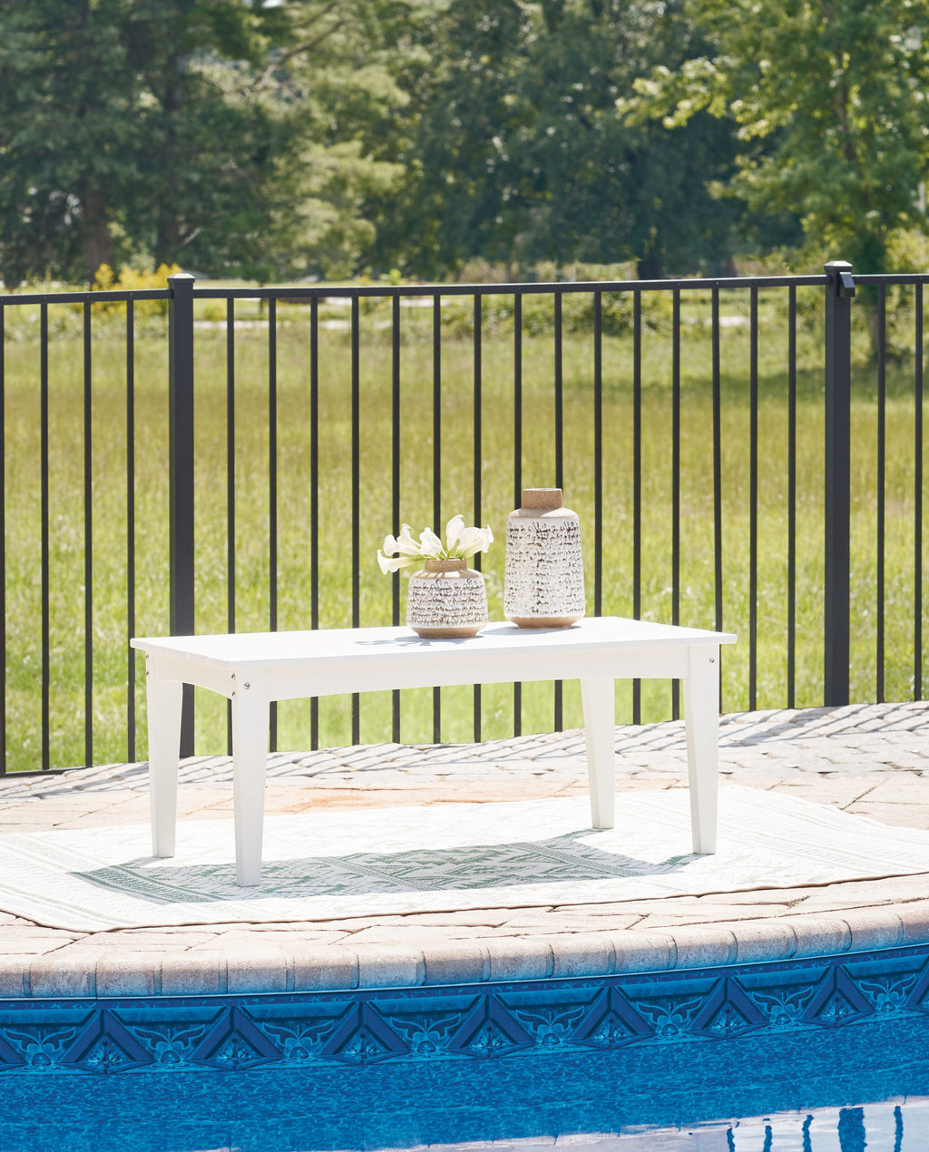 White rectangular cocktail table with four legs and open tabletop