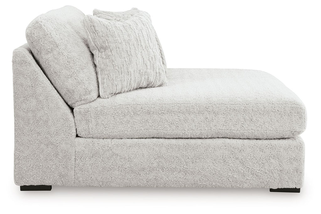 Oversized armless chaise with thick cushions and two textured throw pillows, light gray