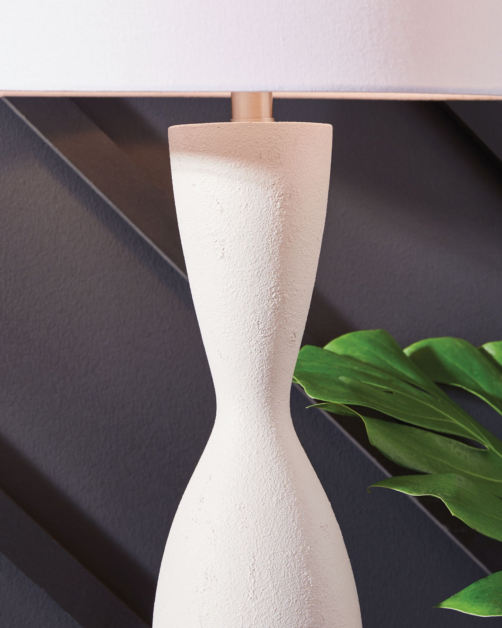 White poly table lamp base with textured finish and fitted white fabric shade