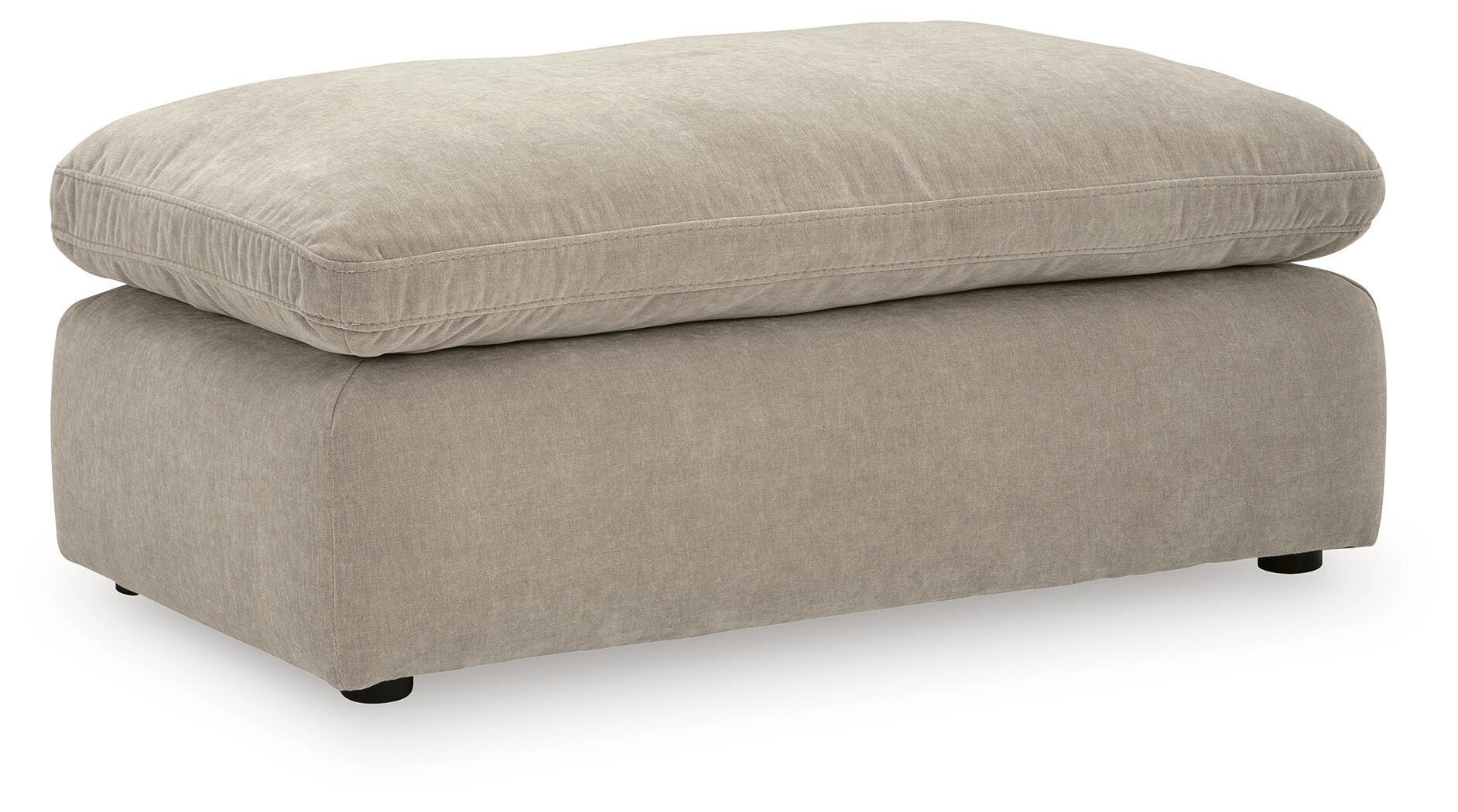 Light gray upholstered ottoman with rounded top and short legs