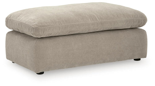 Light gray upholstered ottoman with rounded top and short legs