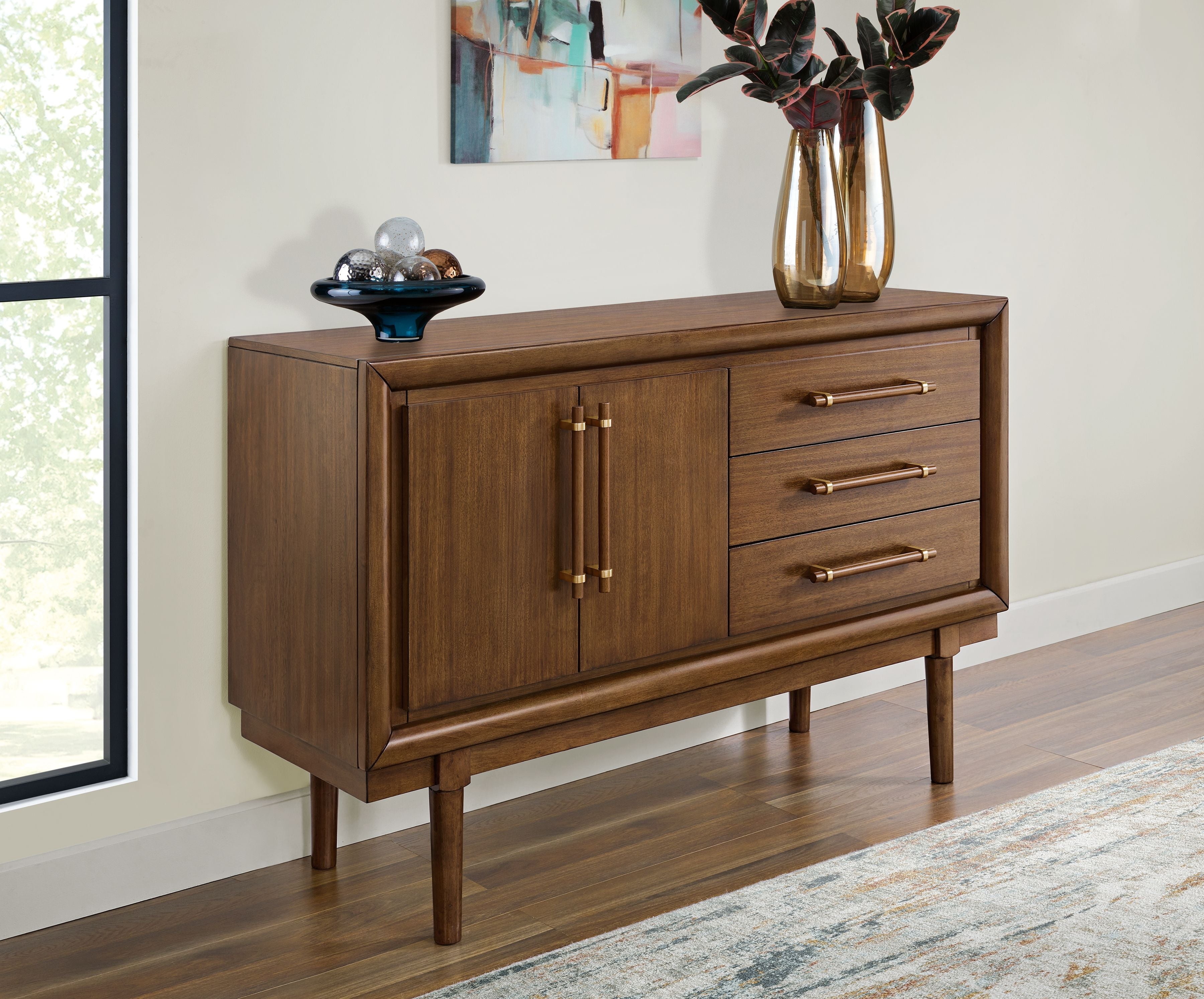 Brown dining room server with two doors and three drawers on four tapered legs.