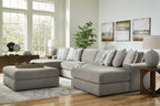 Gray sectional sofa set with chaise corner and stacked neutral striped pillows