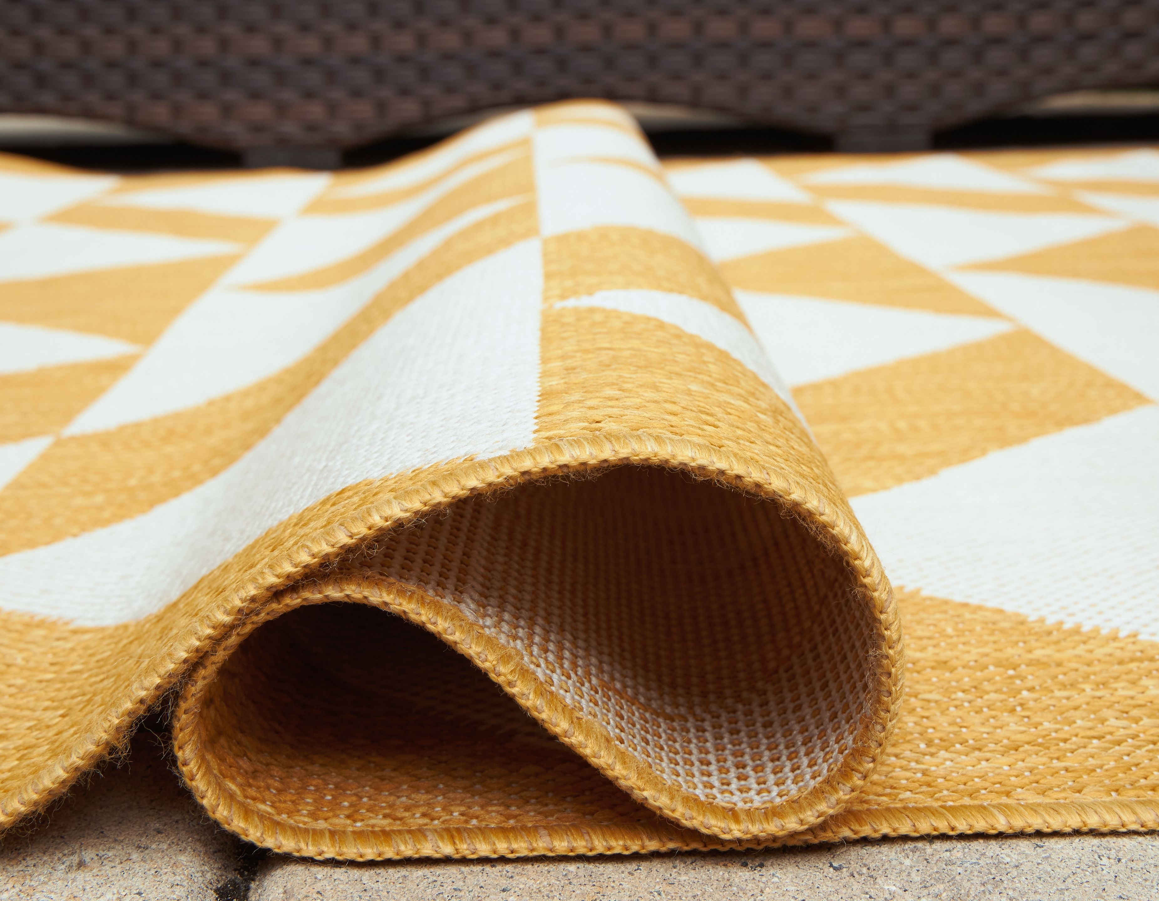 Yellow and white chevron rug folded corner with woven border