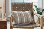 Striped rectangular pillow on wooden chair, light brown and beige vertical stripes