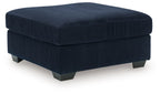 Navy oversized ottoman with ribbed fabric, square padded top, dark legs.