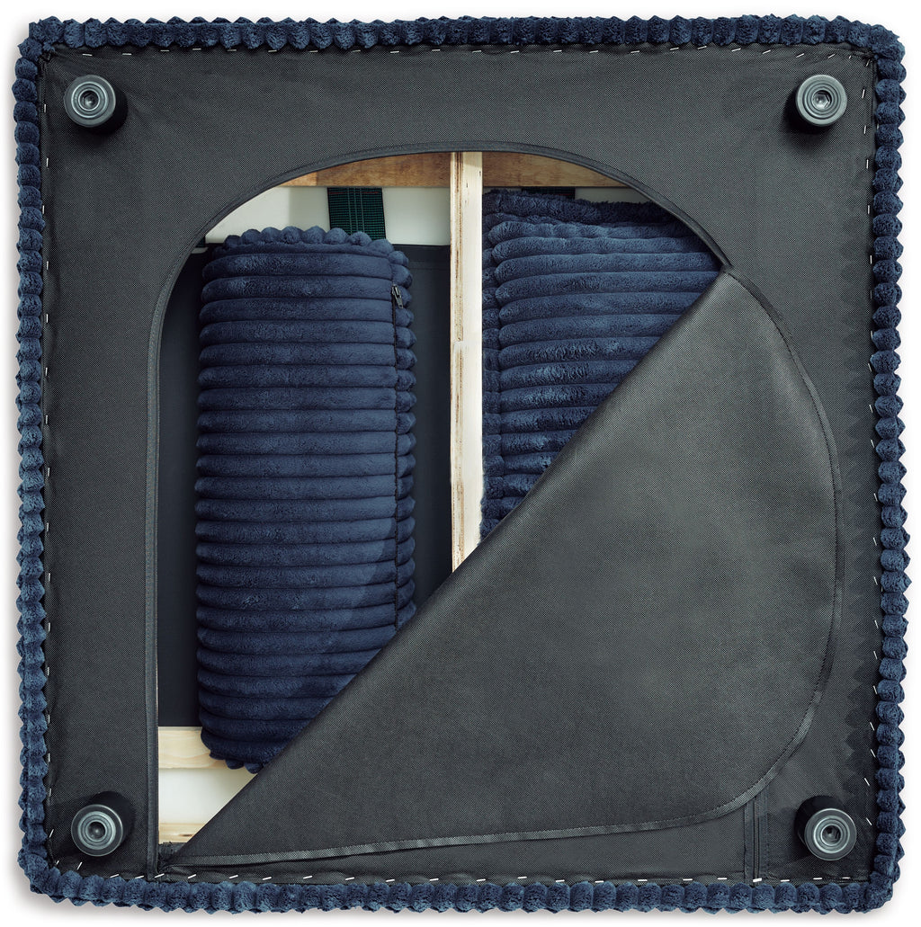 Navy upholstered arched panel with stitched border, fabric swatch for sectional
