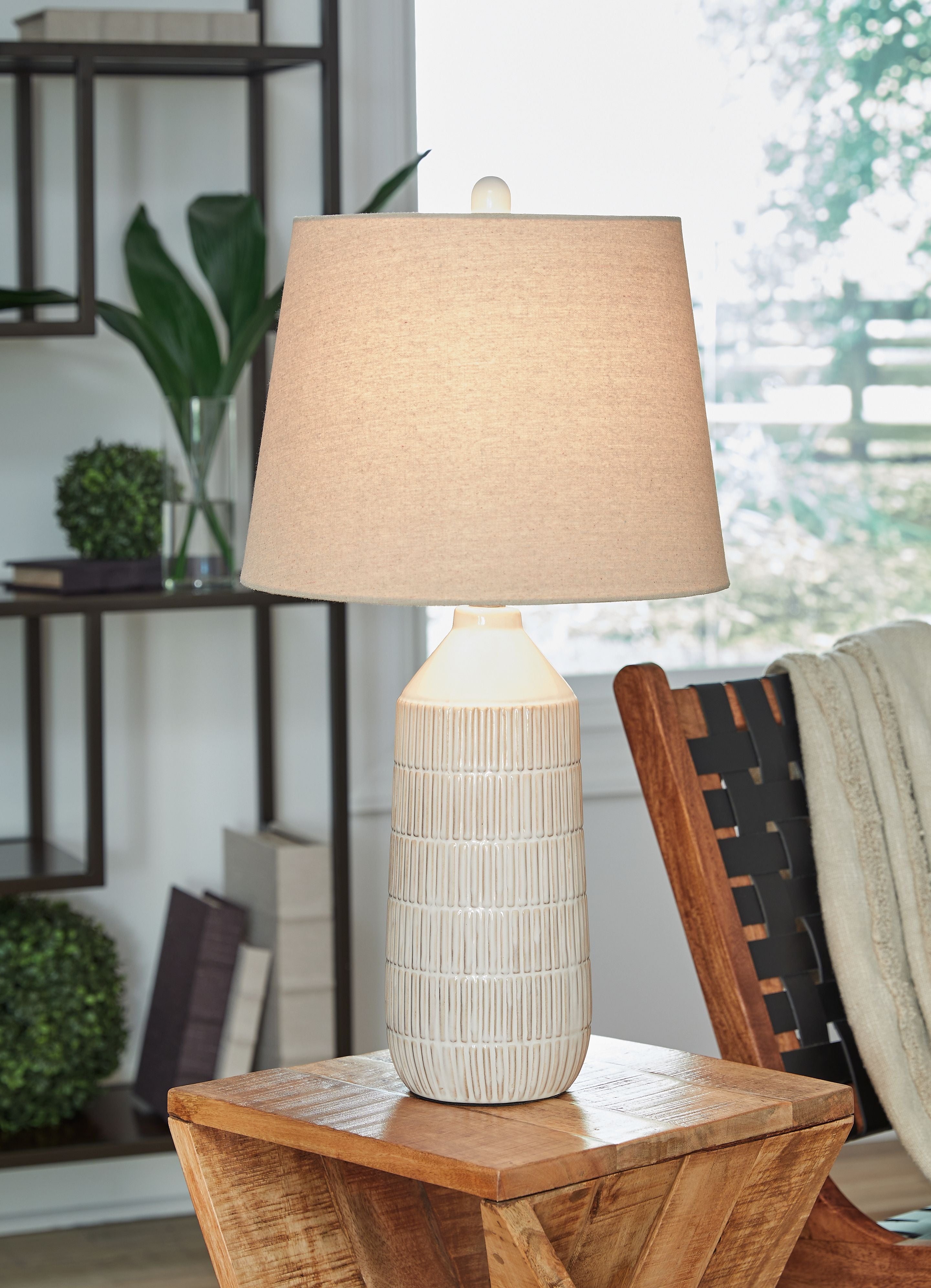 Ceramic table lamp with beige drum shade and off-white ridged ceramic body