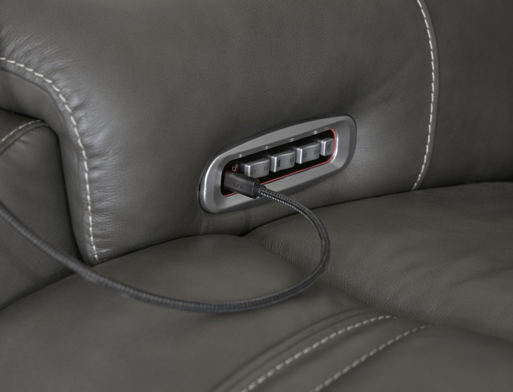 Dark gray reclining seat side power control panel with cord and button slot
