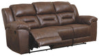Chocolate brown reclining leather sofa with side control panel and curved padded arms