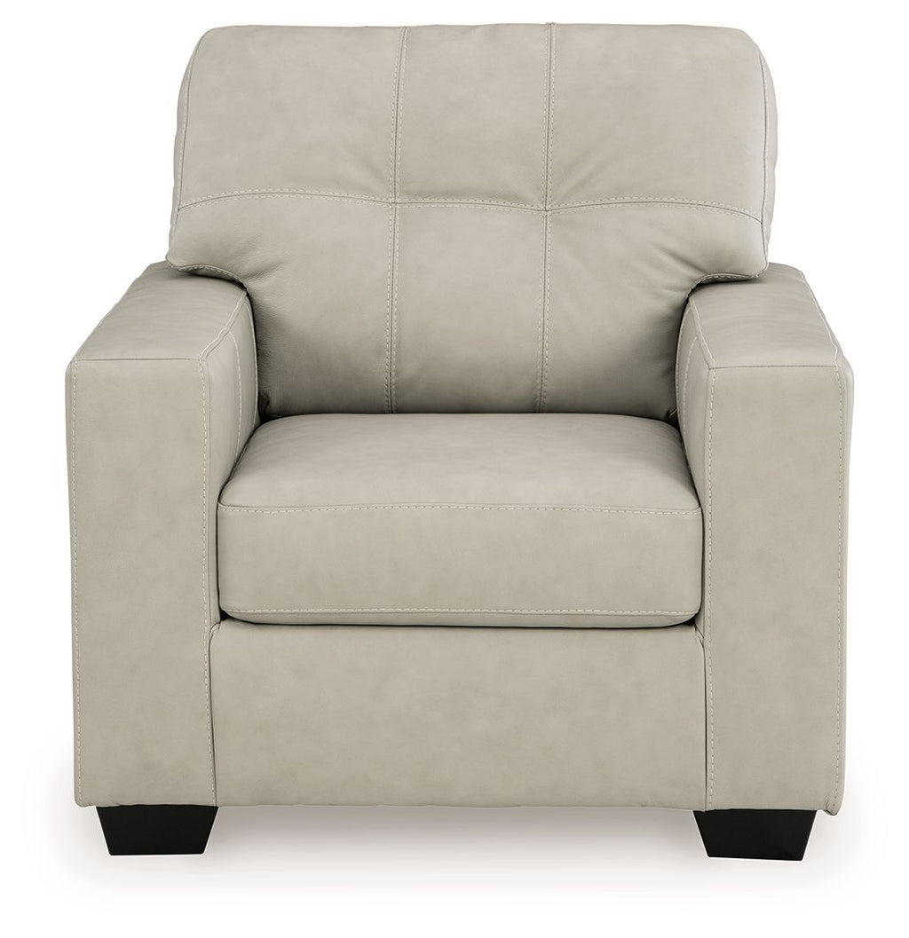 Light beige upholstered accent chair front view with tufted back and wide seat