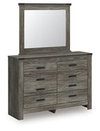 Gray wood dresser with attached mirror and eight drawers