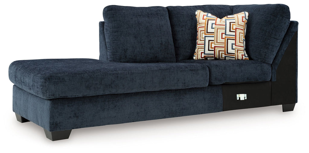 Aviemore dark ink corner chaise with tufted back, armrest, and geometric throw pillows