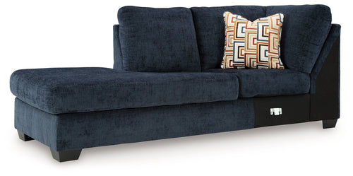 Aviemore dark ink corner chaise with tufted back, armrest, and geometric throw pillows