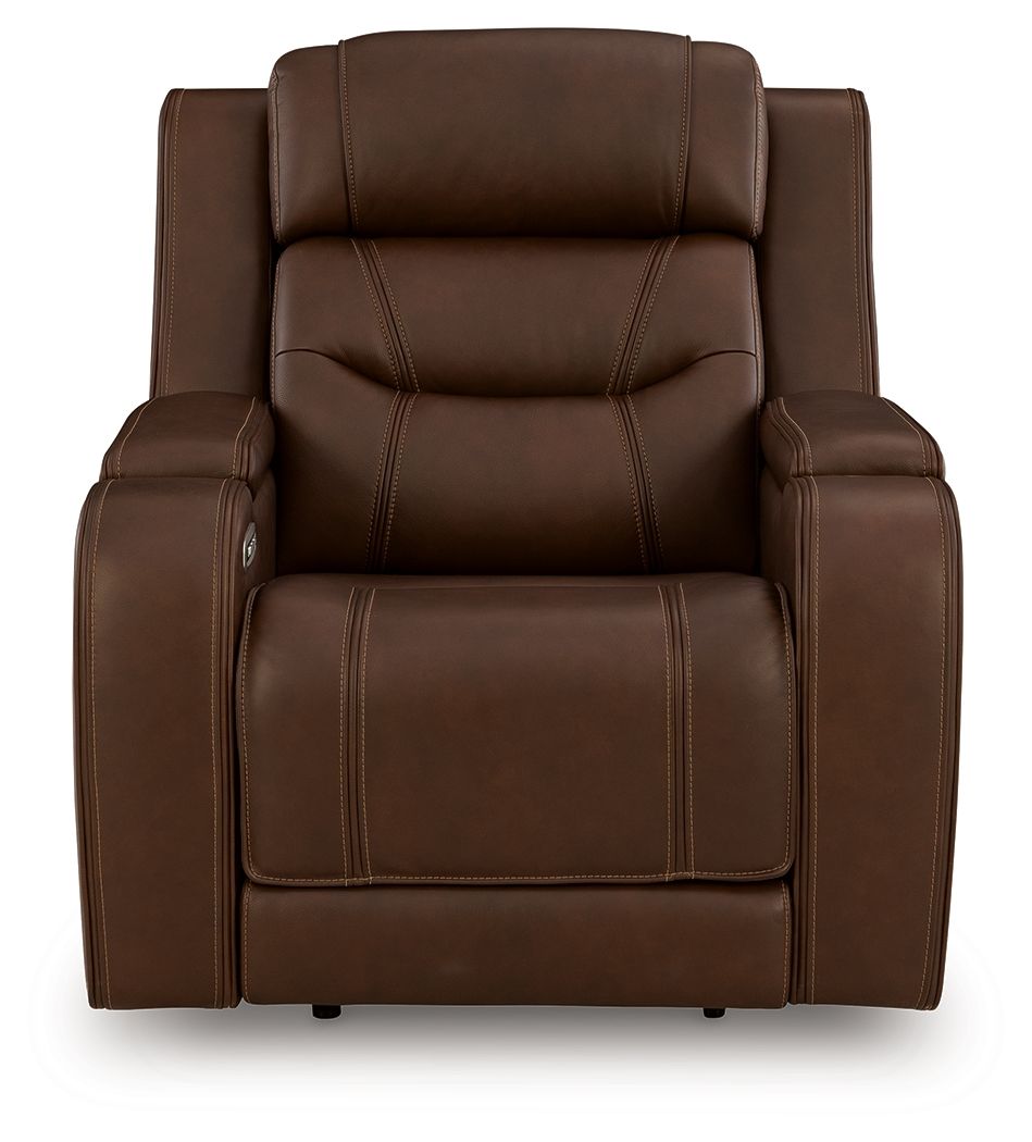 Dark brown power recliner with padded headrest, armrests, and supportive seat cushion
