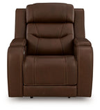 Dark brown power recliner with padded headrest, armrests, and supportive seat cushion