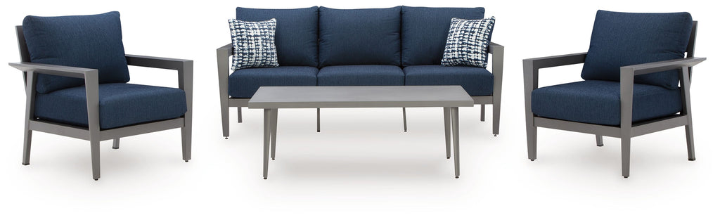 Patio loveseat and armchairs set with navy cushions, gray frames, and patterned pillows