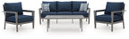 Patio loveseat and armchairs set with navy cushions, gray frames, and patterned pillows