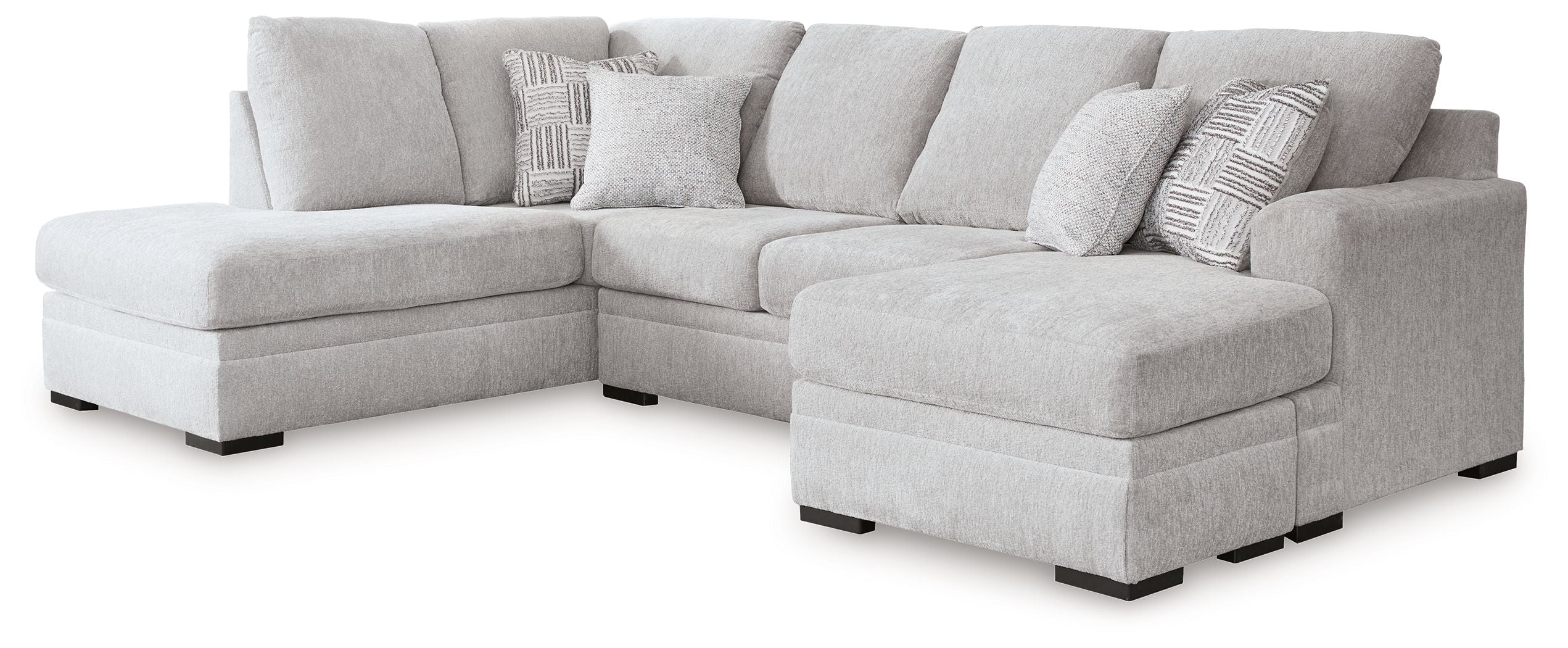 Gray sectional sofa with chaise, multiple back cushions, tufted seat, square dark legs