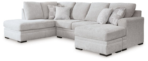 Gray sectional sofa with chaise, multiple back cushions, tufted seat, square dark legs