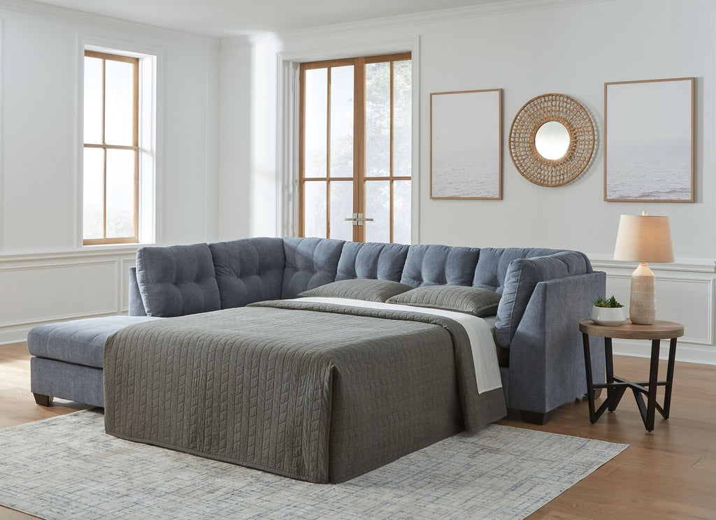 Dark gray corner chaise sleeper sectional sofa with tufted back and sleeper bed