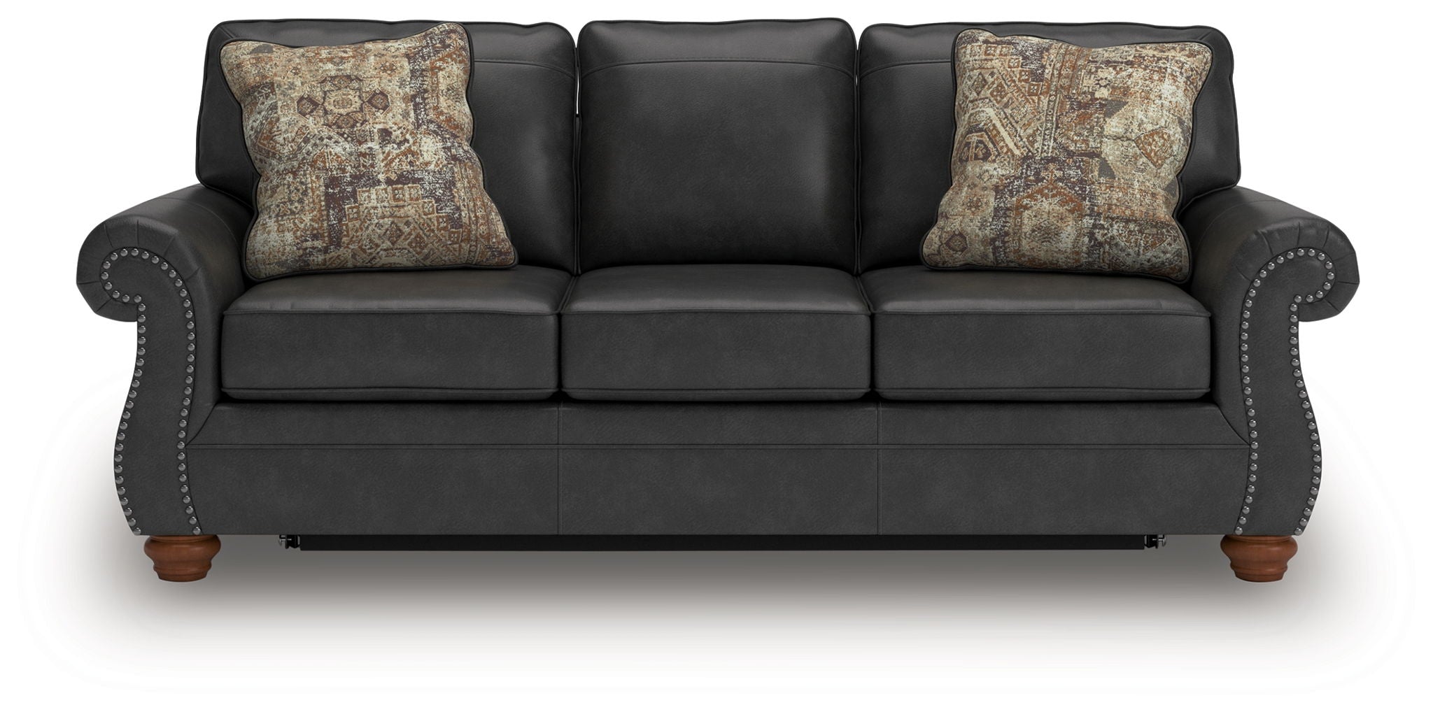 Dark gray sofa sleeper with round arm detailing and two patterned throw pillows