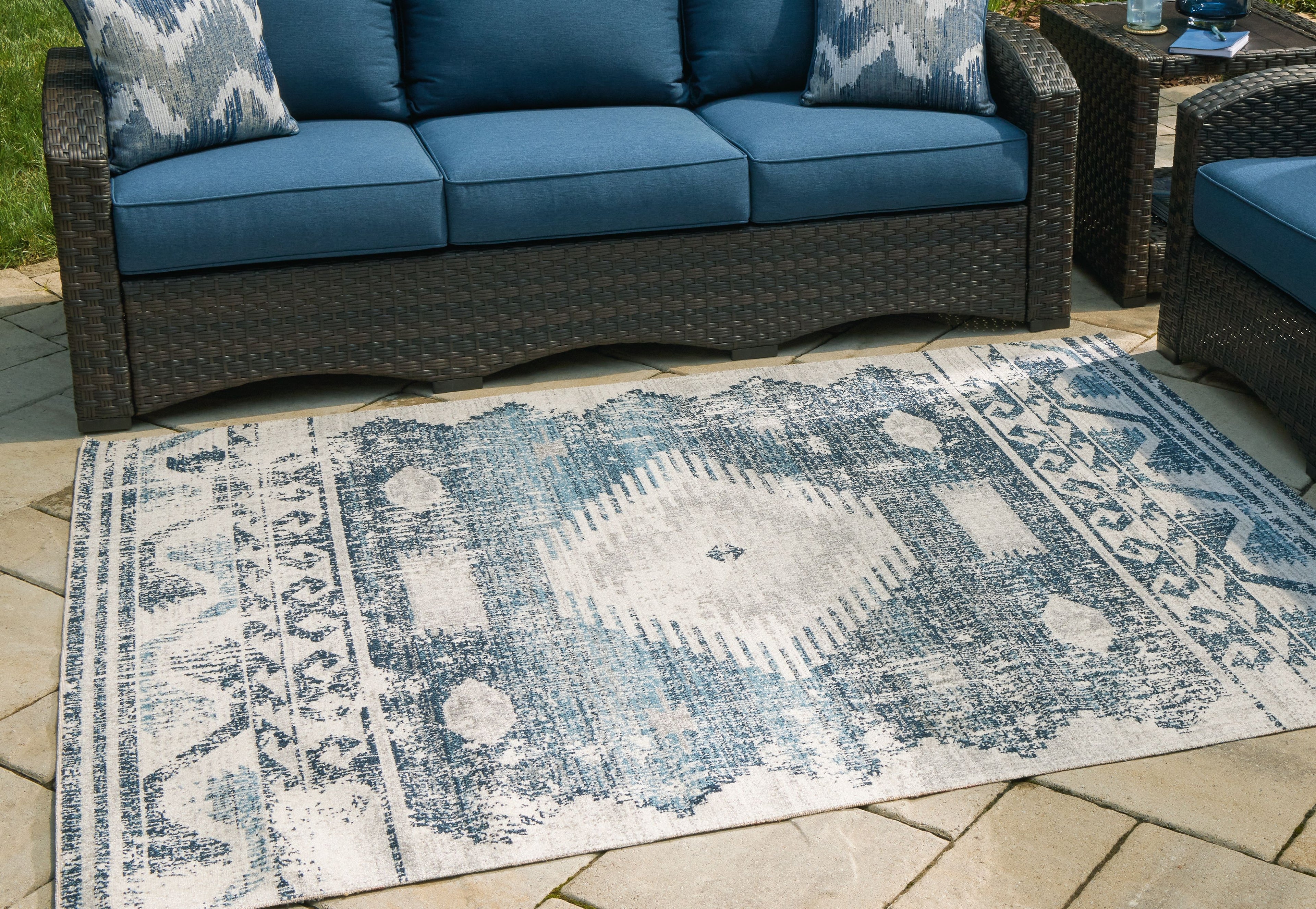 Blue and ivory rectangular area rug with abstract distressed pattern