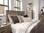 Dark brown panel bed with layered pillows and patterned bedding, side view