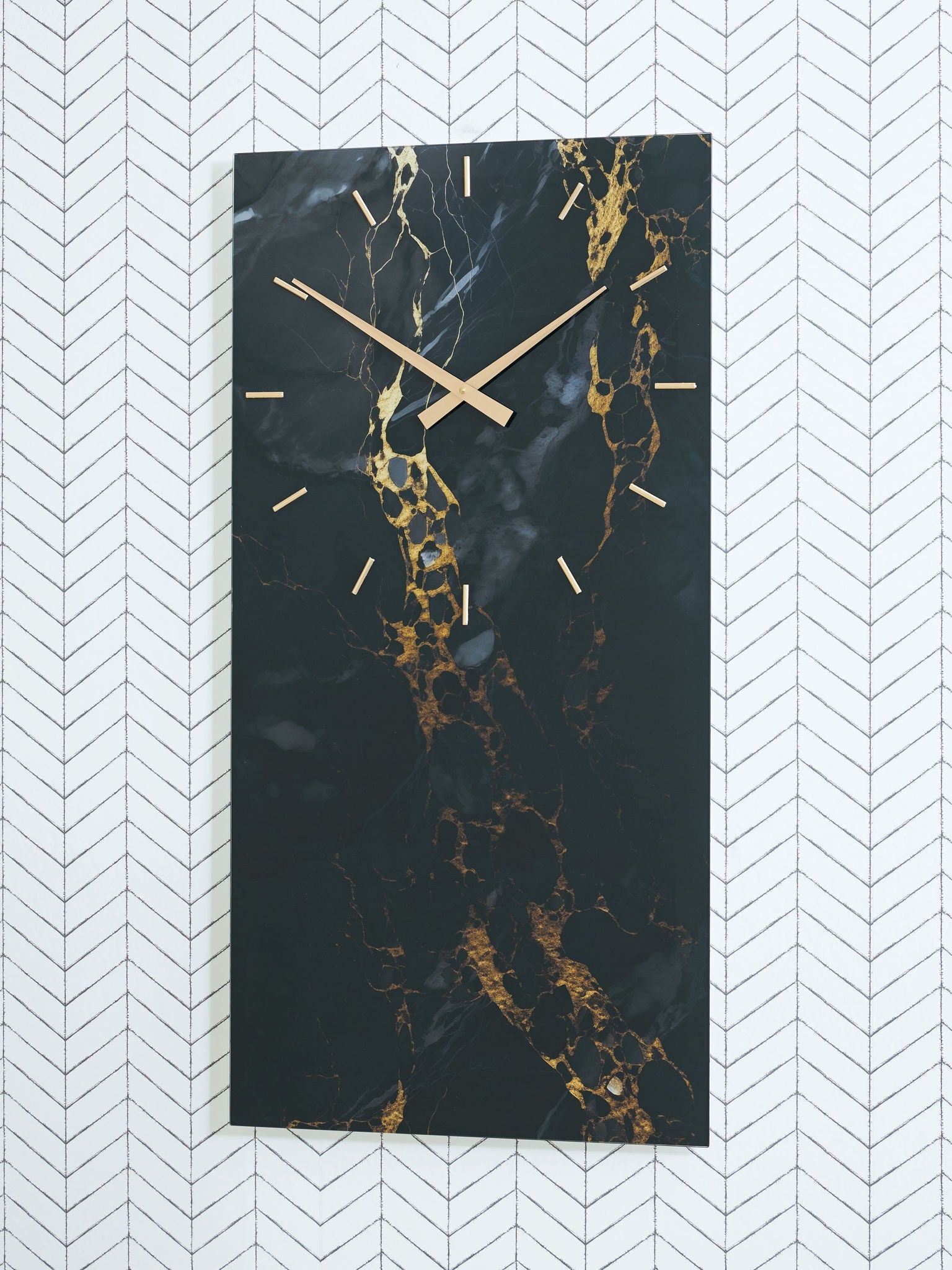 Wall clock with black hands and dark gold-veined marble design on vertical panel