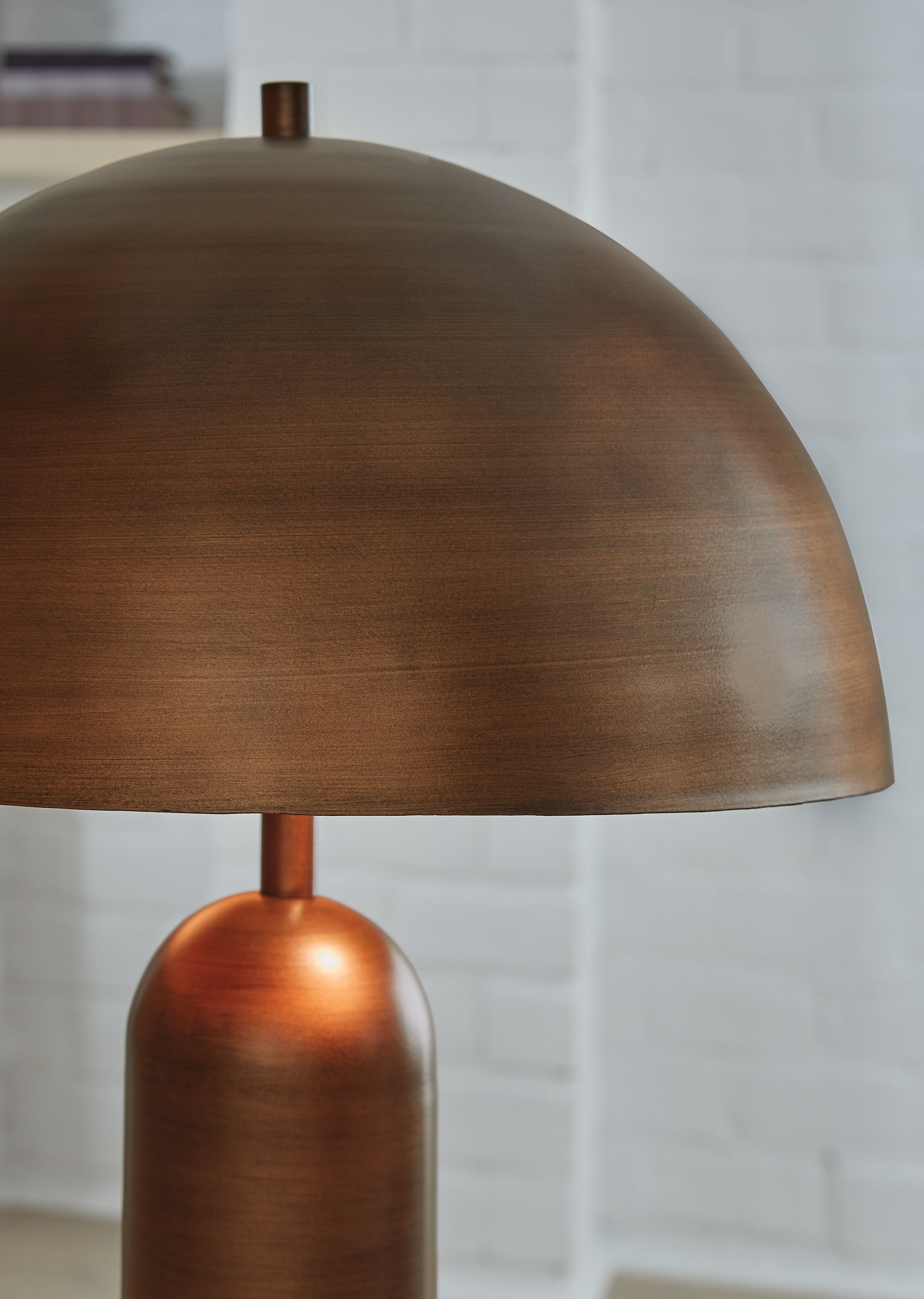 Metal dome shade with bronze finish and cylindrical lamp body