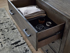 Grayish brown dresser drawer open with interior storage compartments