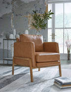 Caramel accent chair with leather-look upholstery, padded arms, and front panel detail