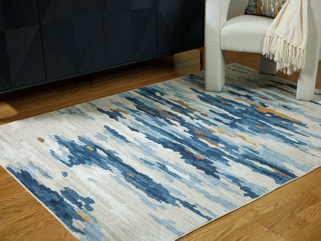 Abstract washable area rug in blue and cream with short flatweave texture