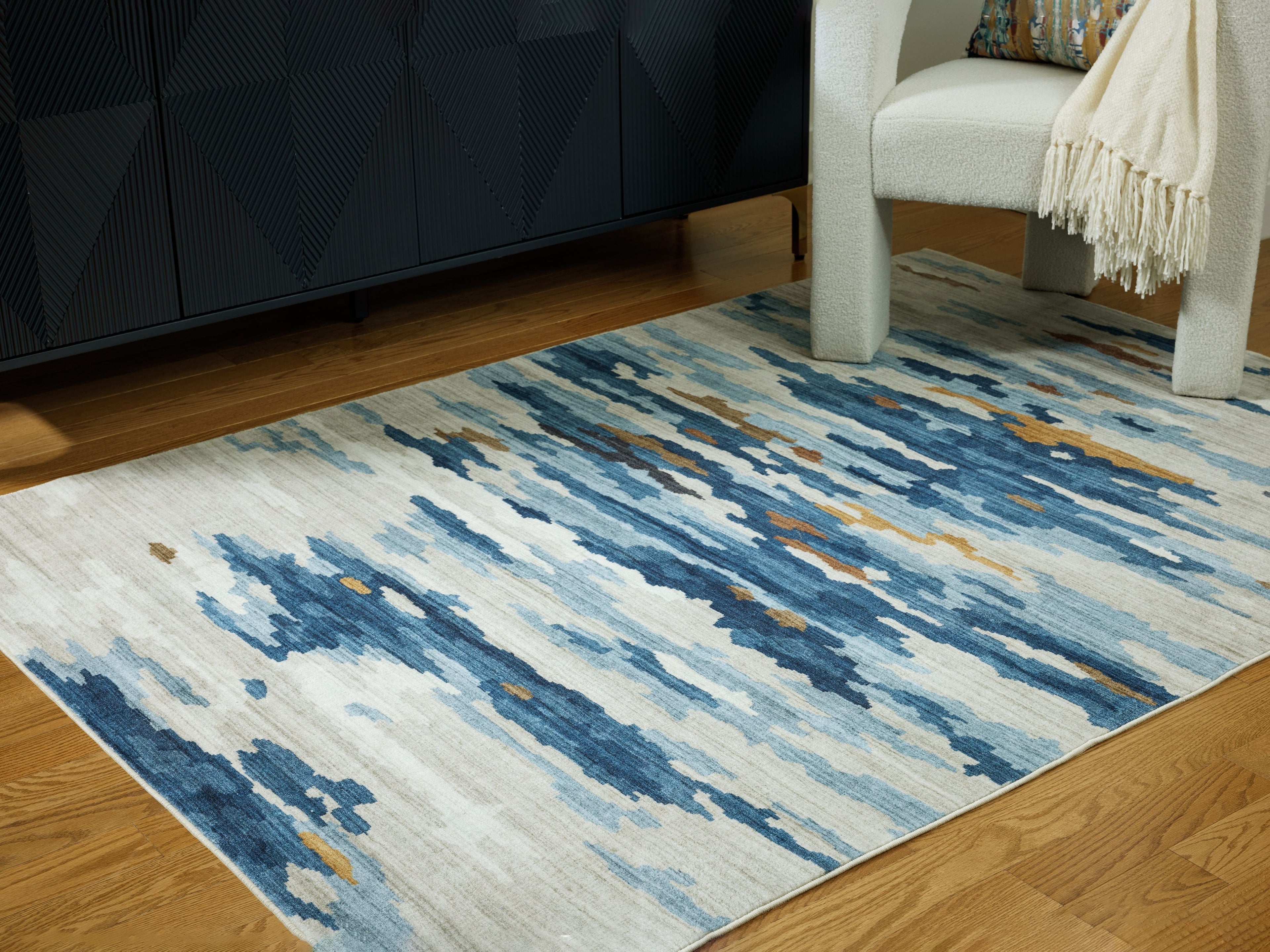 Abstract washable area rug in blue and cream with short flatweave texture