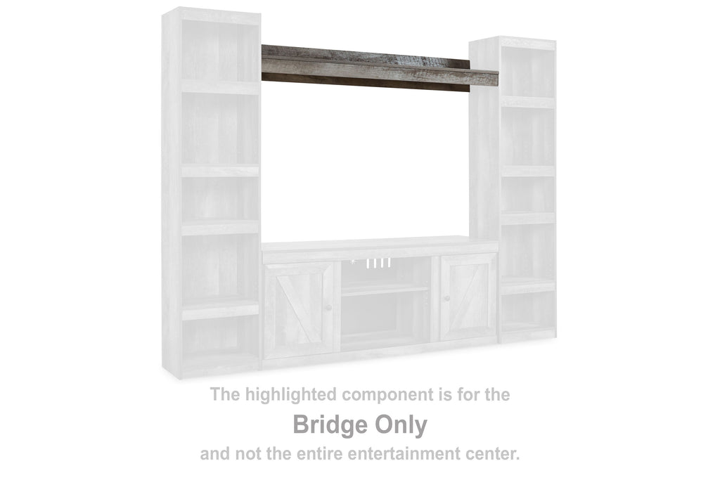 Gray-topped TV bridge unit with open cubby shelves on both sides