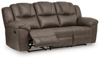 Reclining sofa with tufted back cushions, padded armrests, visible reclining base