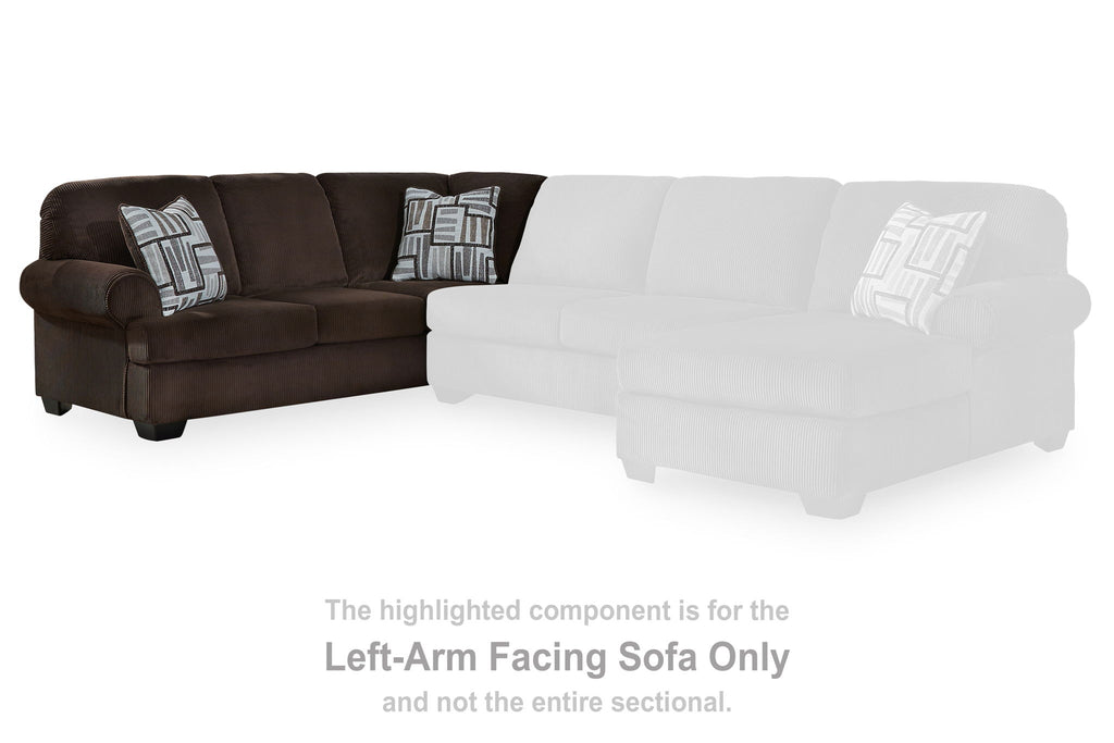 Dark brown left-arm facing sofa section with two patterned pillows and white highlight overlay