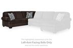Dark brown left-arm facing sofa section with two patterned pillows and white highlight overlay