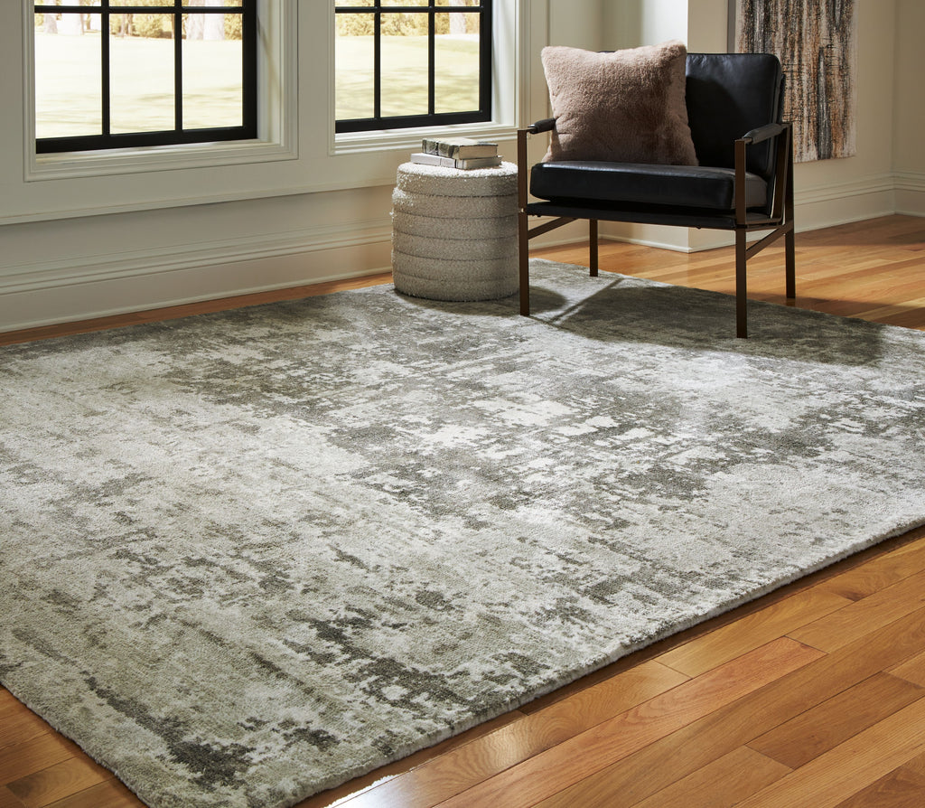 Dark gray area rug with distressed mottled design and textured low pile