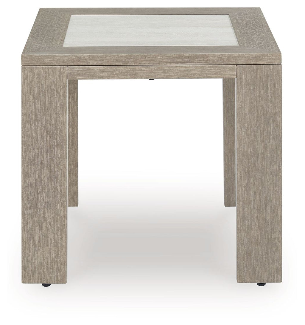 Beige square table with inset top, open underside, and corner feet