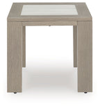 Beige square table with inset top, open underside, and corner feet