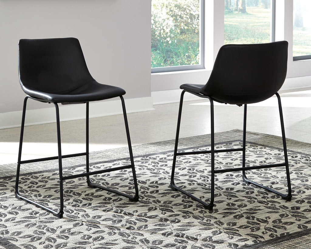 Upholstered bar stool set of 2 with black seats and black metal frames on patterned rug