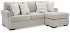 Gray upholstered sectional sofa with chaise and multiple throw pillows