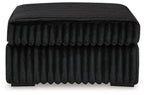 Oversized accent ottoman with ribbed fabric and rounded top, dark finish