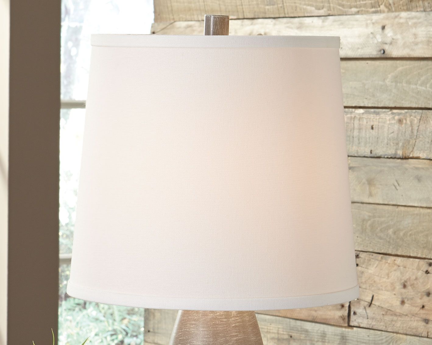 Table lamp with white fabric shade and dark gray textured base