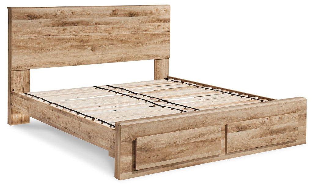 Storage bed frame in light wood with slatted base and solid side rails