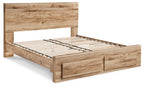 Storage bed frame in light wood with slatted base and solid side rails