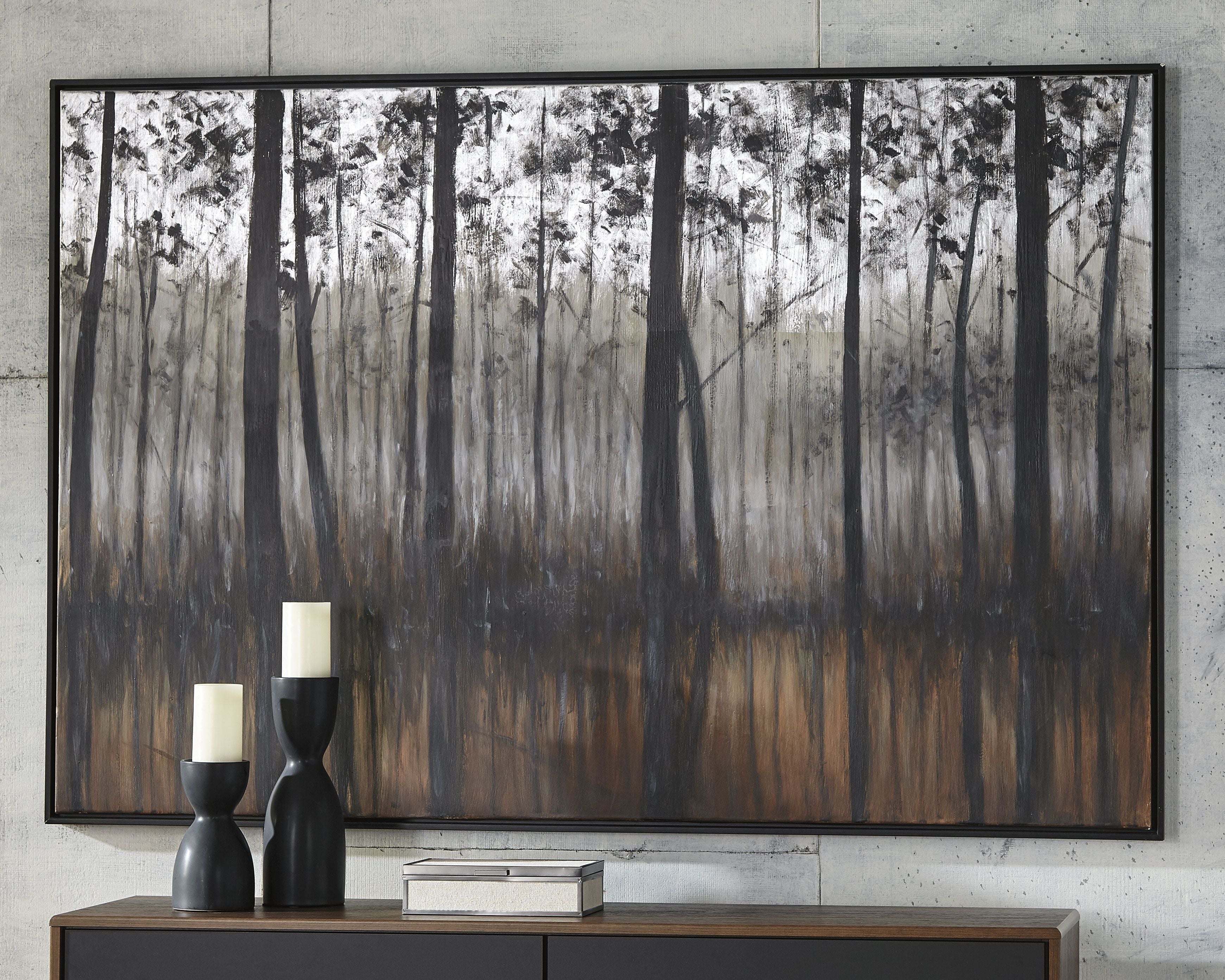 Framed forest wall art with vertical black tree silhouettes over gray and dark brown.