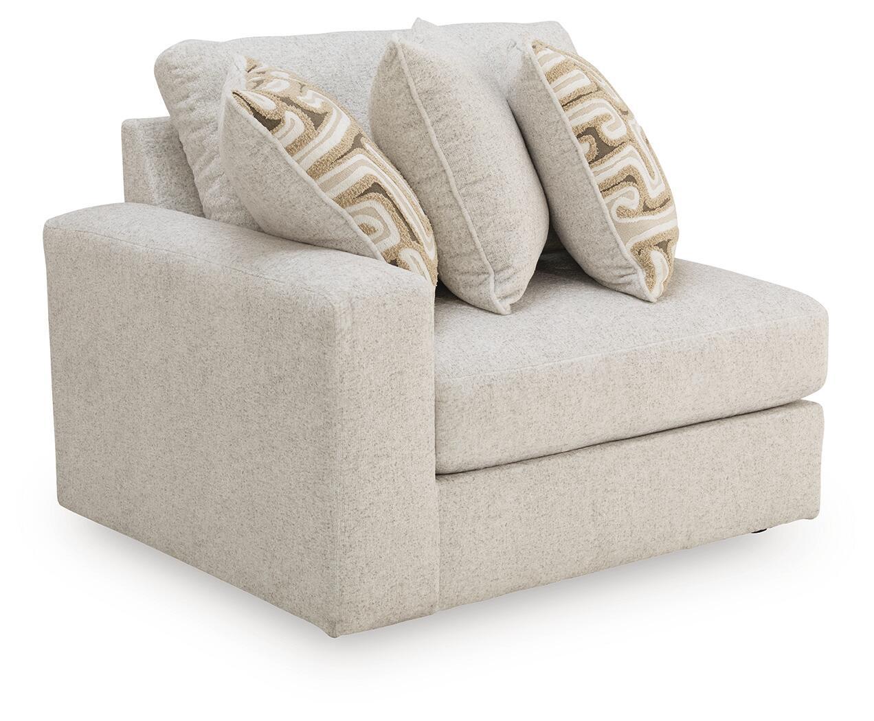 Kestrie LAF corner chair in light beige fabric with three patterned throw pillows