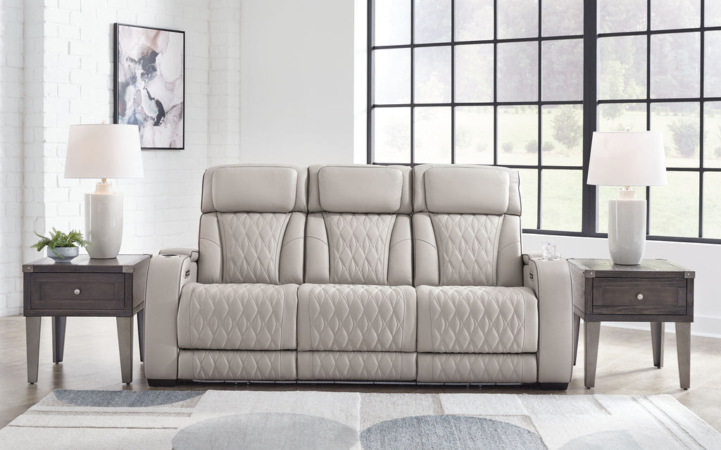 Gray 3-seat reclining sofa with quilted upholstery and three padded headrests